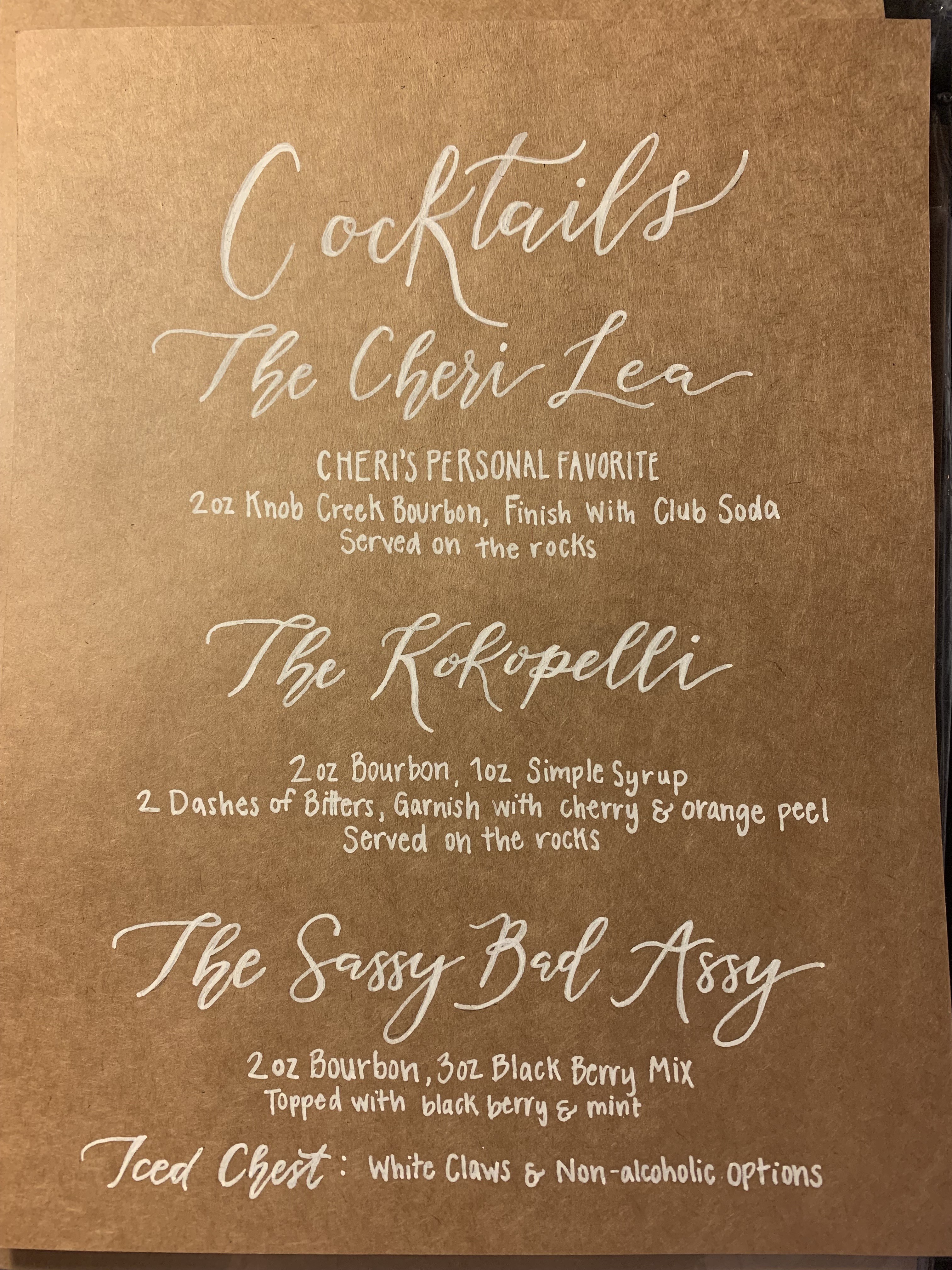 Hand-lettered cocktail menu on kraft paper